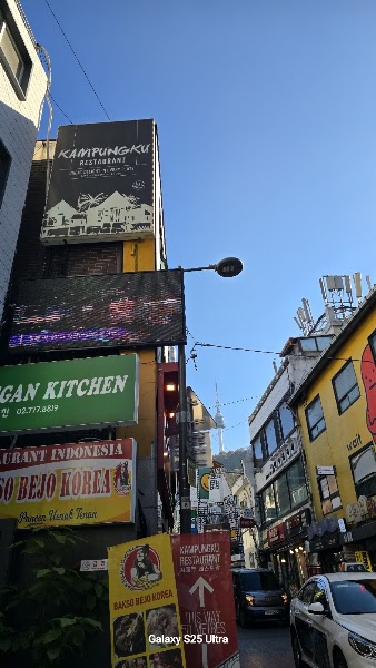 Signage for Bakso Bejo Korea restaurant in Myeongdong, Seoul, with a view of N Seoul Tower in the distance