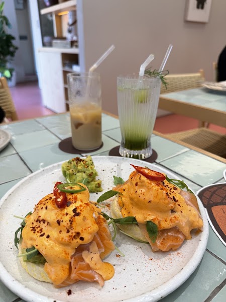 Close-up of salmon eggs benedict served with mashed avocado at VEVERKA Café