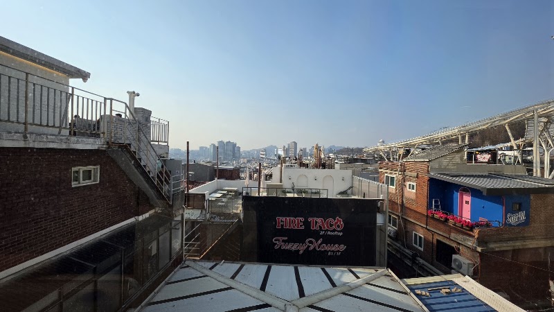 Open rooftop cityscape view of Yongsan neighborhood from Sowol-ro