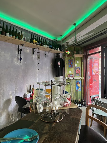 Intimate corner inside Gitana featuring wine bottle displays and wooden shelving
