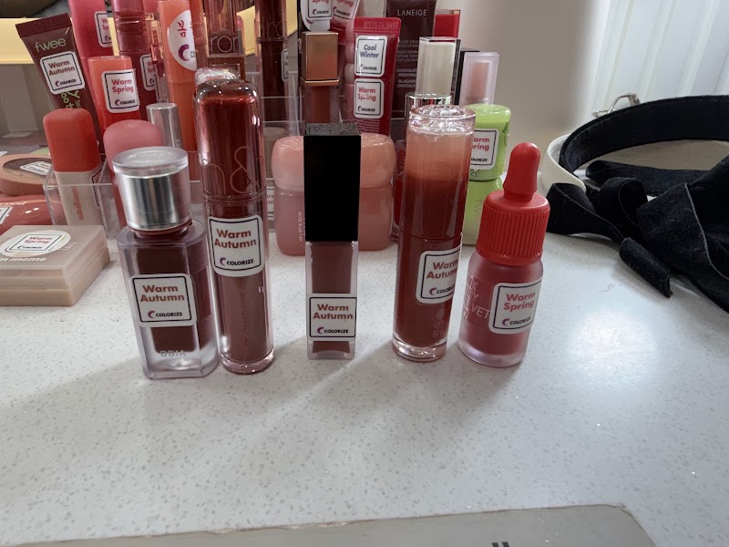 Collection of cosmetic lip products labeled for personal color analysis on a white surface