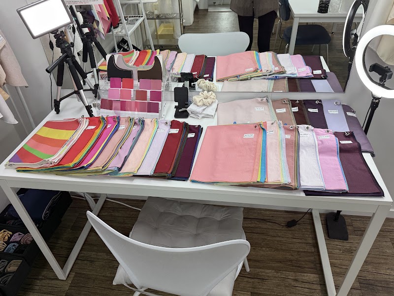 A table with many colorful fabric swatches used for personal color analysis