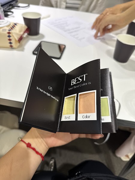 Client holding physical color swatch passbook with fabric samples