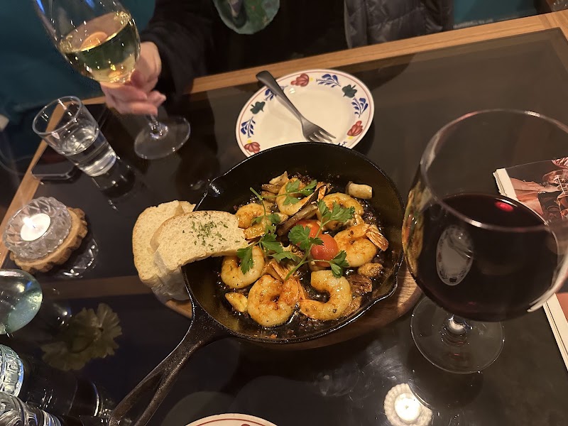 Savory skillet dish served on a candlelit dining table with wine glasses
