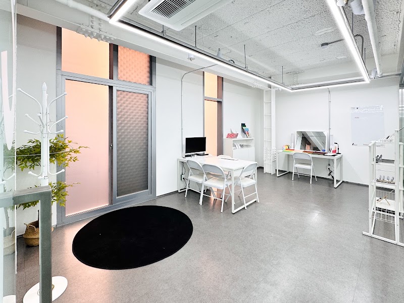Studio consultation tables and diagnostic fabric drapes in Myeongdong