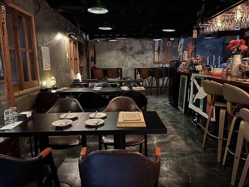 Main dining area with leather chairs and view of the bar station