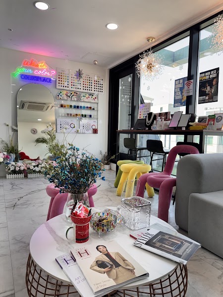Consultation studio interior with arched mirror, lounge chairs, and color palettes