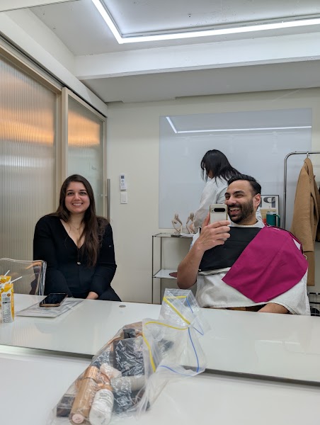Client receiving color analysis consultation with magenta drape