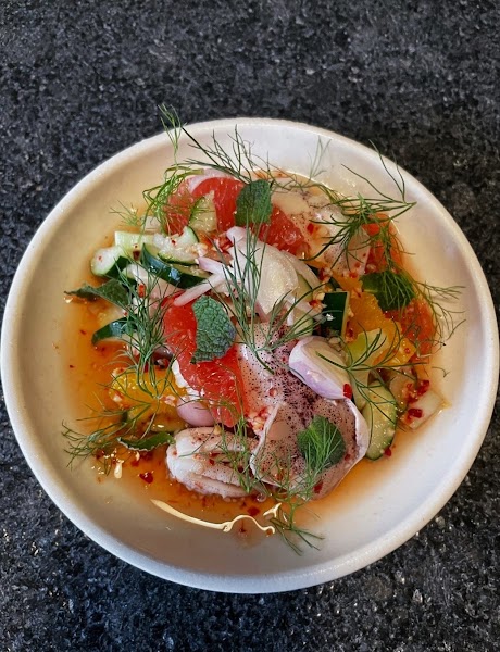 Seafood and citrus salad bowl with cucumber, shallots, and fresh herbs
