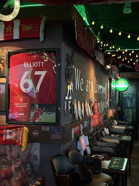 Interior of sports bar in Seoul decorated with Liverpool FC jerseys and scarves