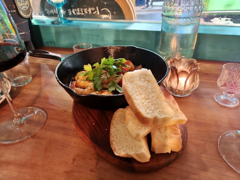 Spanish-style garlic prawns in a cast iron skillet served with crusty bread