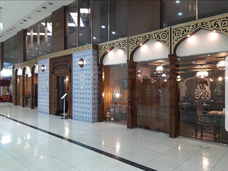 Entrance and storefront of Saffron restaurant in Seoul featuring intricate Islamic-style architectural details and blue tile work