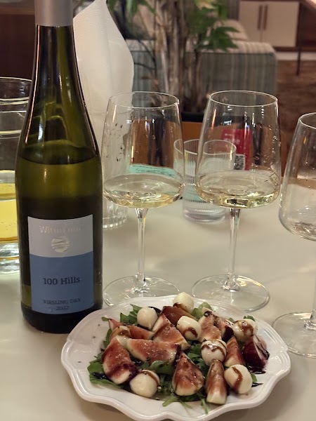 Wine bottle with fig and mozzarella fresh salad plate