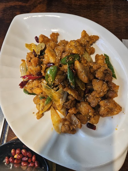 Crispy stir-fried chicken tossed with dried red chili peppers, scallions, and roasted peanuts