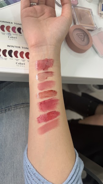 Forearm lipstick swatches compared against Summer and Winter seasonal color theory cards
