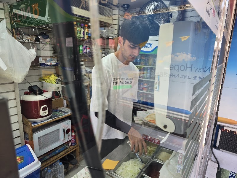Staff preparing kebab ingredients in the food prep station
