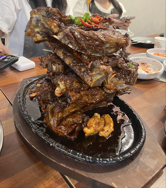 Glazed pork ribs stacked high on cast iron skillet