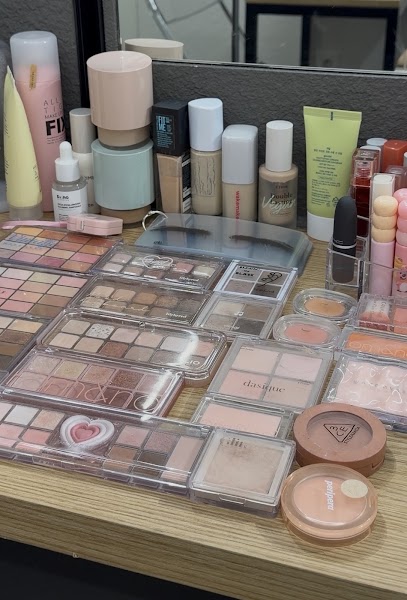 Vanity surface with curated makeup palettes and cosmetic bottles
