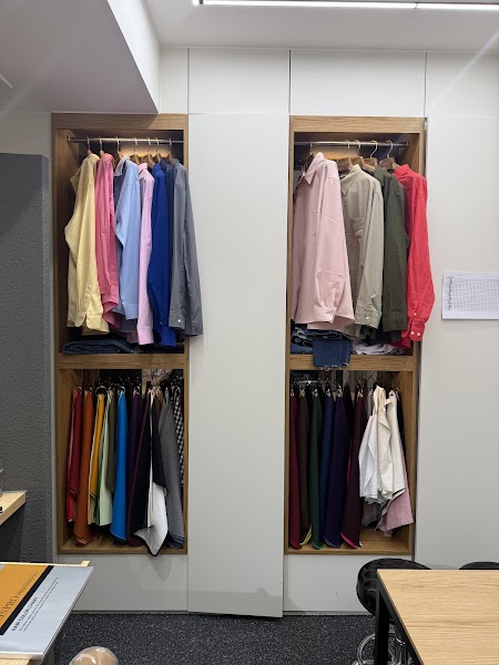 Storage closets featuring organized shirts and fabric swatches in consultation room