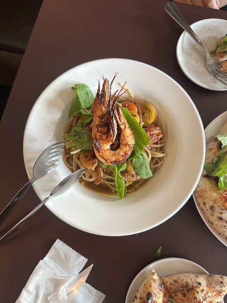Spaghetti pasta with grilled whole prawn, herbs, and tomatoes