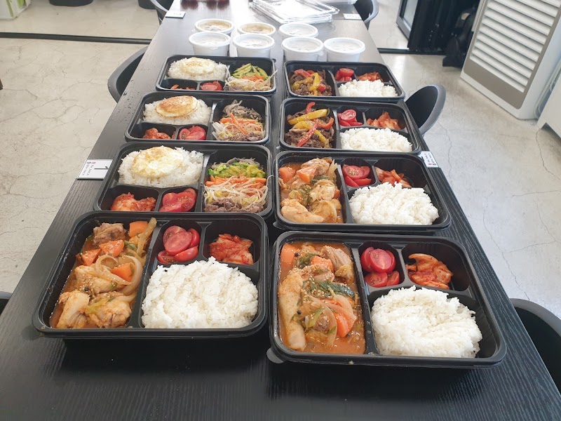 Halal Korean bento meal boxes prepared on long dining table