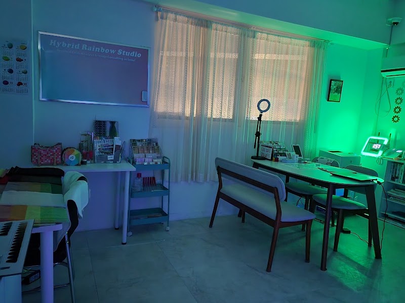 Interior of Hybrid Rainbow Studio featuring tables, chairs, and colorful professional consulting equipment.