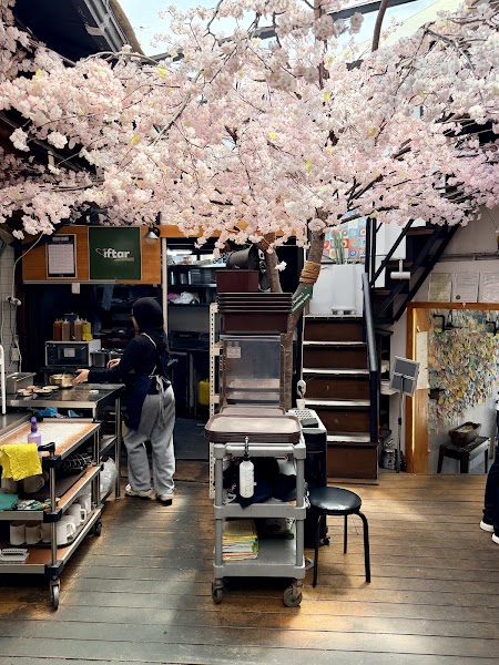 Traditional wooden Hanok interior with central cherry blossom canopy at IFTAR