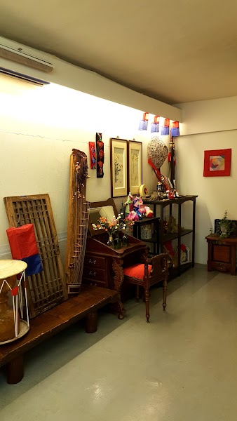 Interior display of traditional Korean musical instruments and furniture at It's Me Photo Studio.
