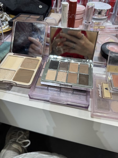 Open eyeshadow and powder palettes on vanity table