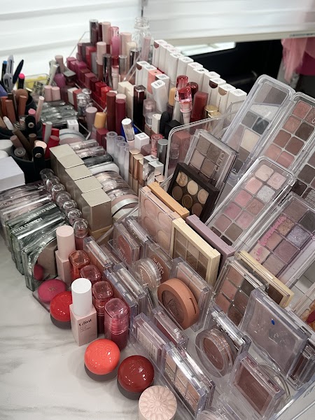 Organized cosmetic palettes, lipsticks, and compact cushions arranged on marble consultation desk