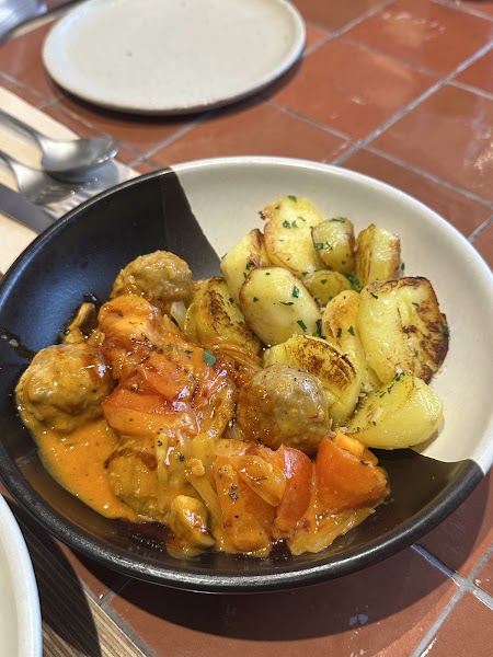 Meatballs and roasted potatoes in rich tomato glaze served at VEVERKA