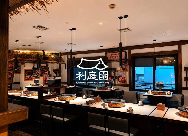 Interior of Lee Jung Won Korean BBQ restaurant in Seoul with wooden accents and integrated grill tables.