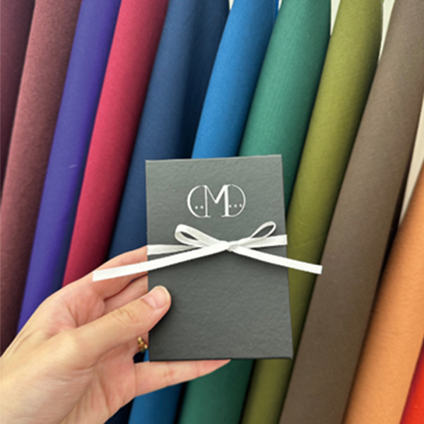 Branded gift box kit displayed against personal color analysis fabric swatches