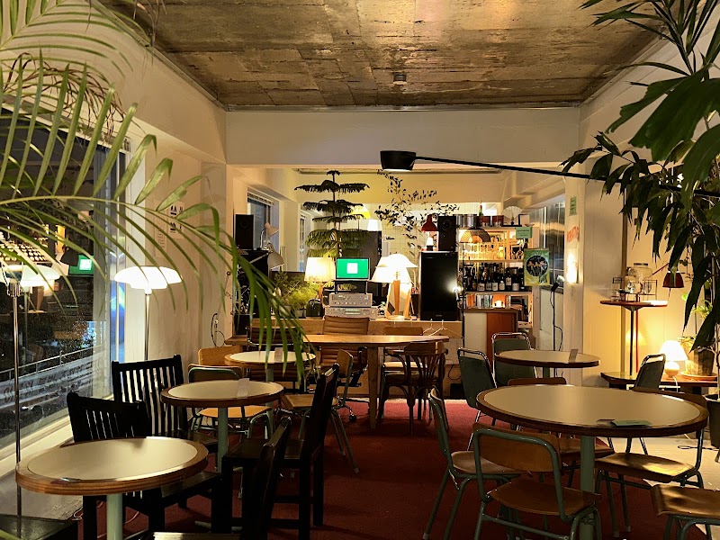 Interior dining space of Underbar Seoul with round tables, vintage lighting, and audio gear