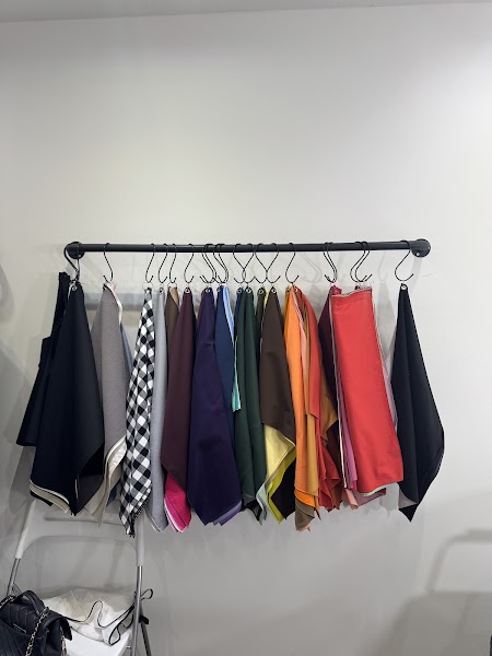 Multi-seasonal fabric draping swatches hung systematically in studio