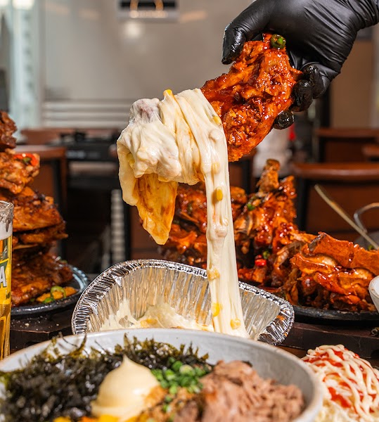 Melted mozzarella cheese stretched over spicy pork rib