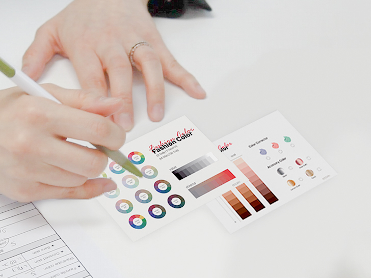 Consultant pointing at color chart with diagnostic tools during session