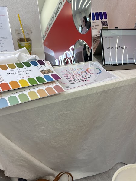 Personal color analysis consultation table with color swatches, tablet, and mirror