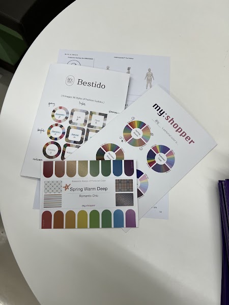 Personal color chart cards and Spring Warm diagnostic guides on table