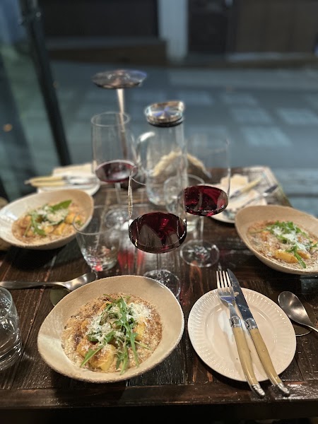 Dinner table at Leseuteu with house specialty dishes and glasses of red wine