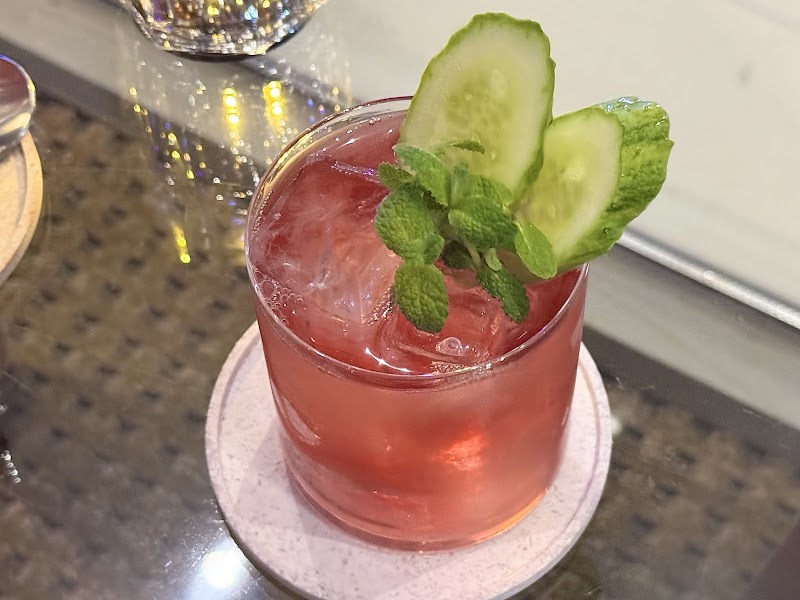 Chilled cocktail garnished with cucumber and fresh botanical mint