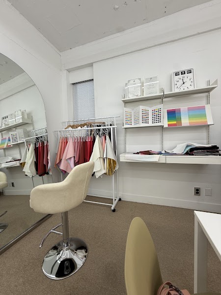 Interior of a personal color consultation studio in Seoul with fabric drapes, shelves, and a mirror.