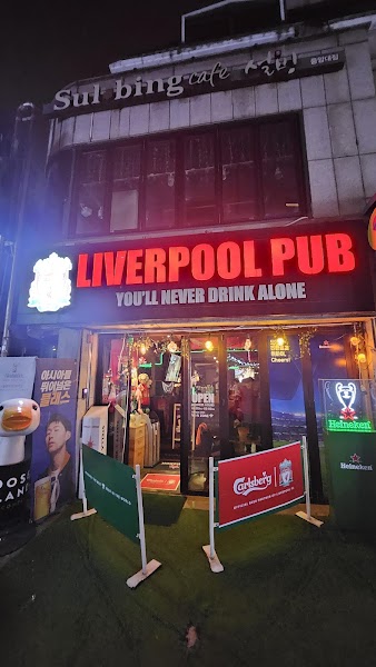 Exterior storefront of Liverpool Pub in Seoul at night with bright red neon signage