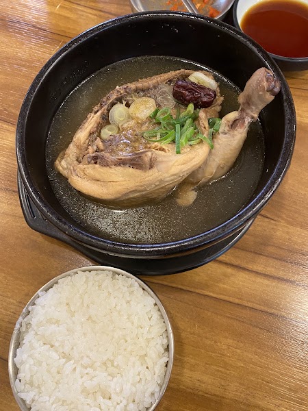 Samgyetang chicken soup in black stone pot with rice