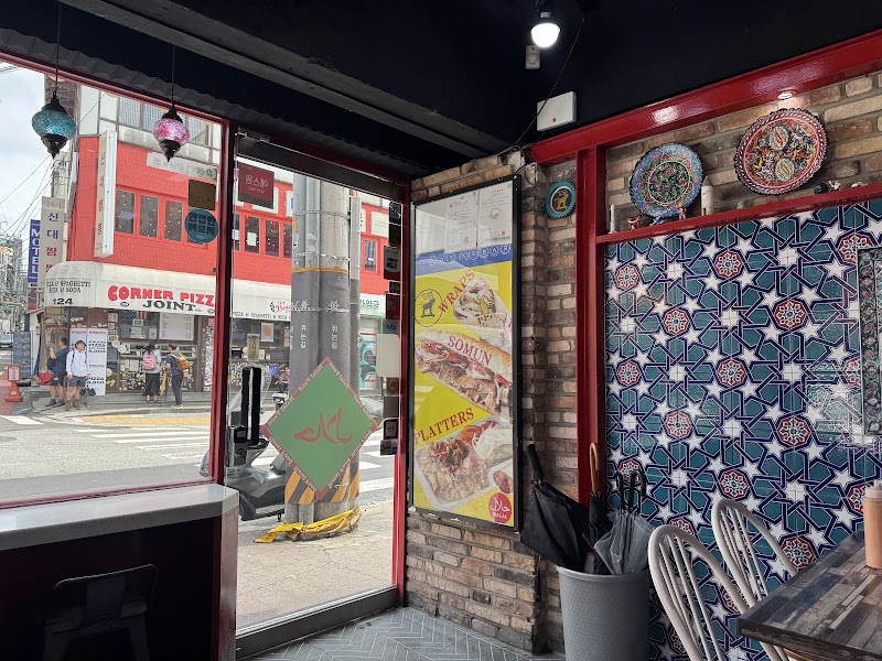 View looking out through glass entrance onto the street corner