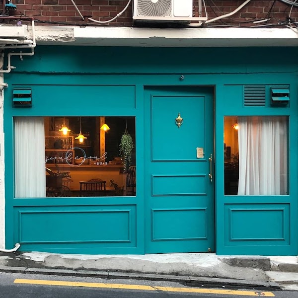 Daylight view of the teal facade and front entrance of Seoul'n'Soul