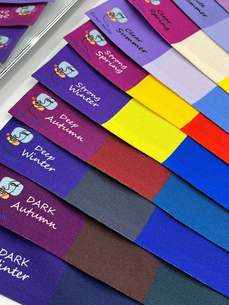 Set of layered fabric color swatches for personal color analysis at Color Holic