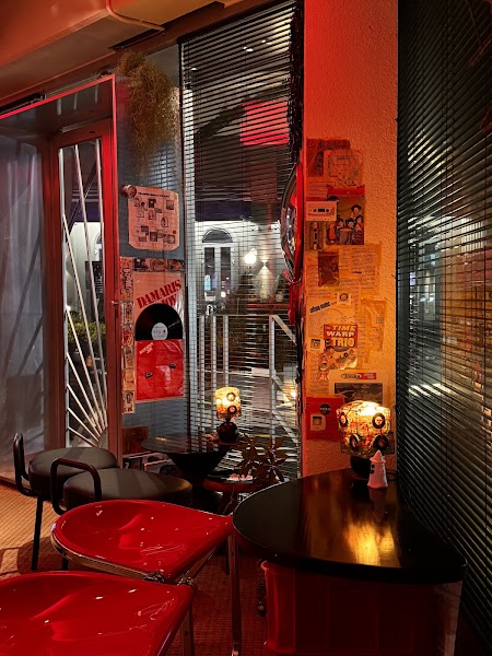 Corner red chairs and vintage poster wall