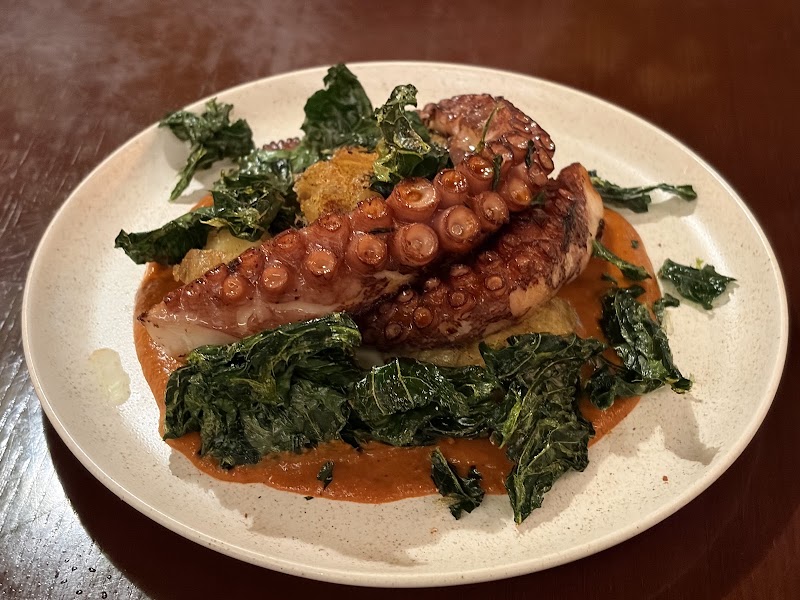 Grilled octopus tentacles served over rich puree with crispy kale at Tapa Copa