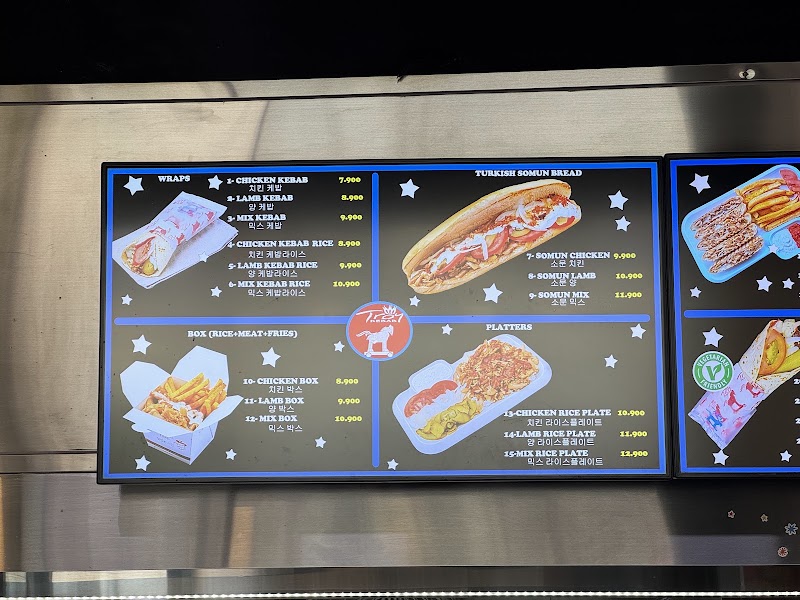 Digital menu board displaying various meal options like wraps, somun bread, boxes, and platters
